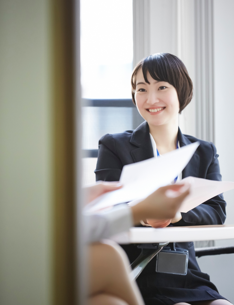 HOIIY Singapore CSR initiative: A business professional reviewing project papers for the 8L Glass Air Fryer development.